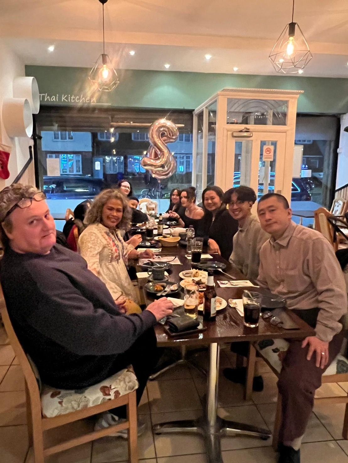 Guests at a long table in the Chart Thai dining room